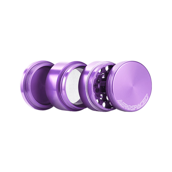 Open Purple 4 piece grinder against a white background.